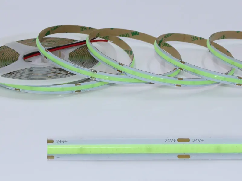 Unlit colored COB LED strips coiled to show tinted phosphor bands