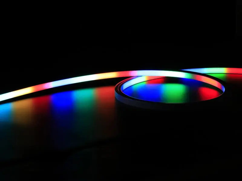Addressable LED neon flex glowing a smooth color gradient on black