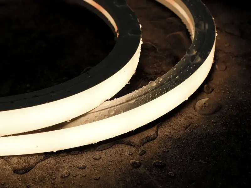 Waterproof LED strip curving along a wet pool edge with an even light line
