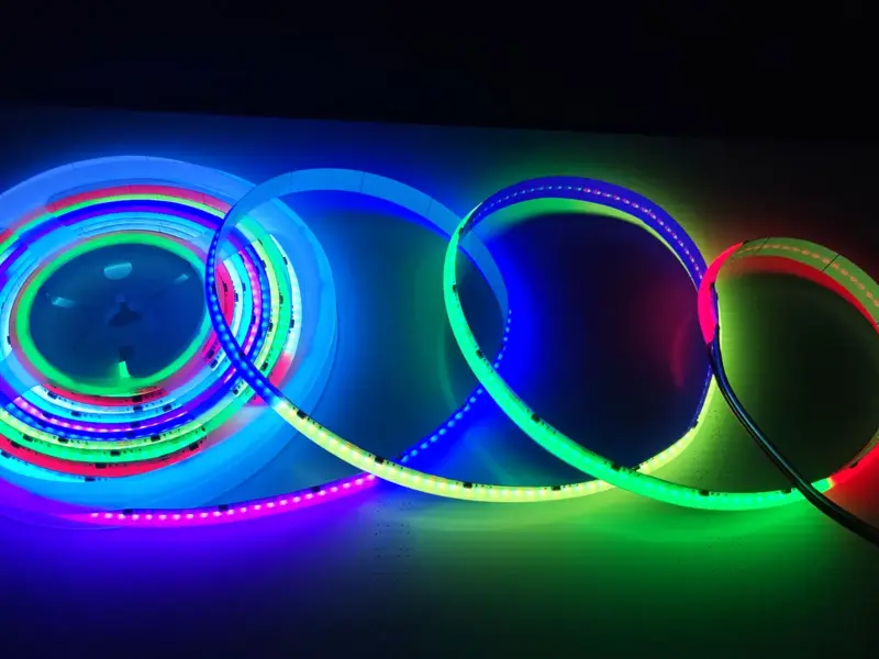 Close-up of dot-free RGB COB LED strip coils glowing in mixed colors