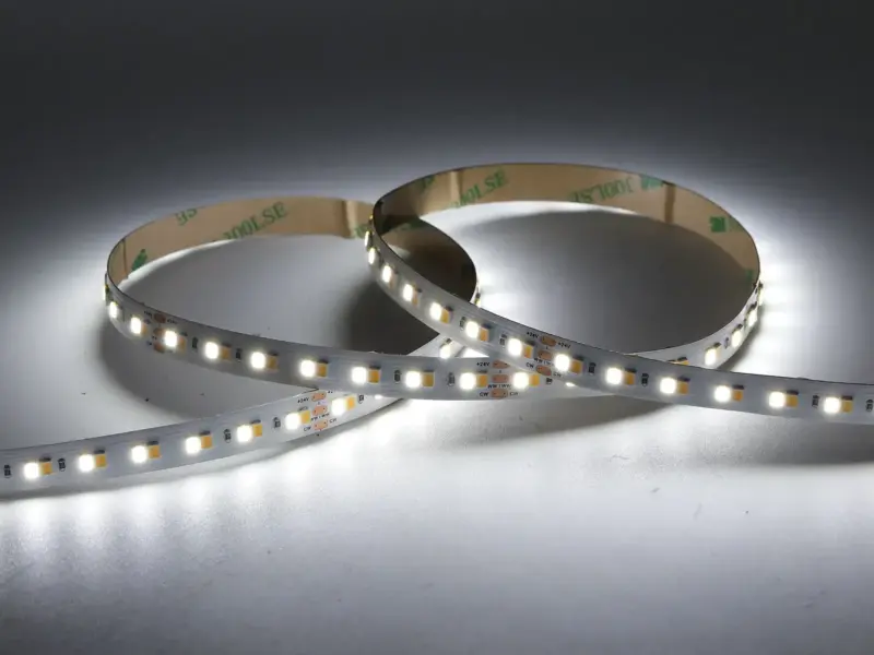 Full-spectrum SMD LED strip coiled to show dense chip rows on a clean white PCB