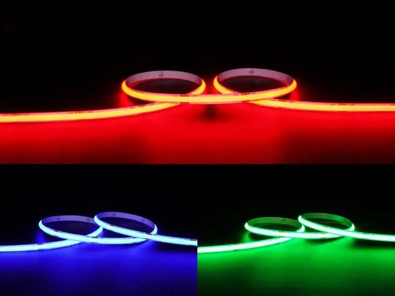 CSP RGB strip shown lit in red, blue and green, each colour washing the surface behind the coiled strip