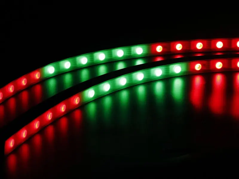 LED strip lit in separately controlled red and green segments against a black background