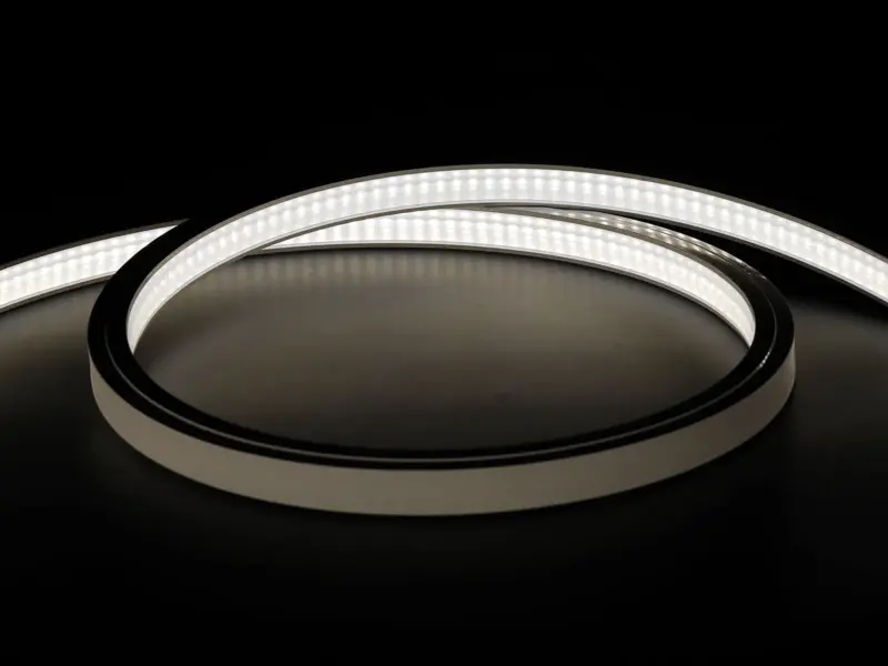 Silicone-jacketed LED strip coiled and lit in cool white, continuous even-lit face with no visible LED dots