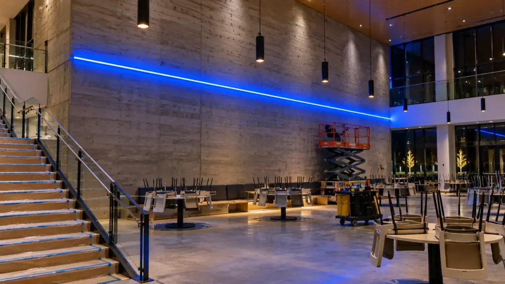 Blue LED neon flex line lit in a university student center the night before opening, protection still down
