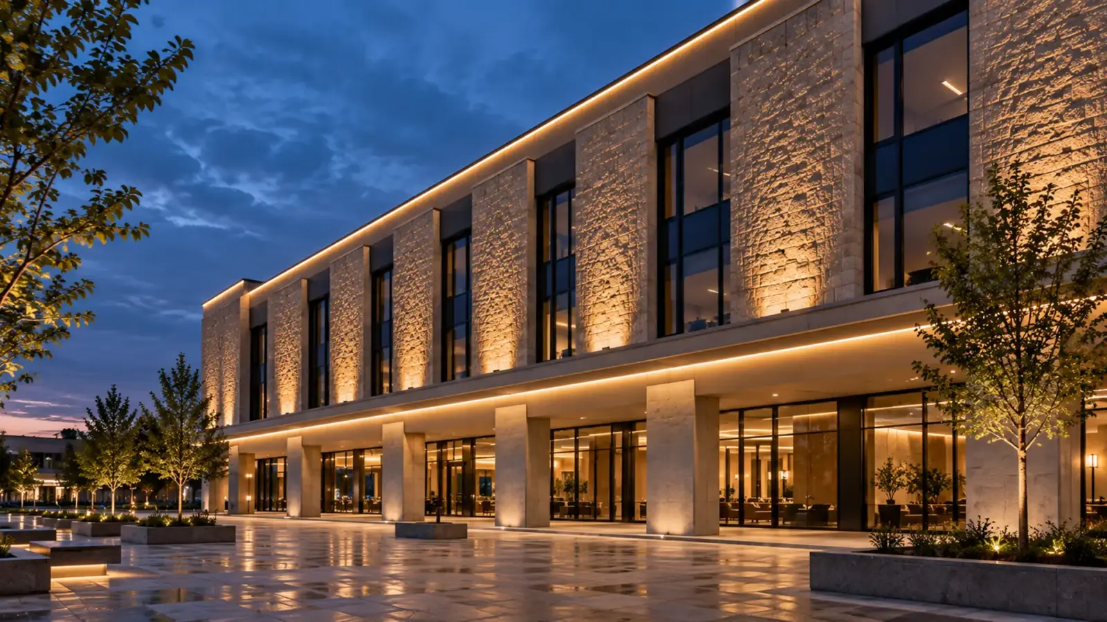 Commercial building facade at dusk with grazed masonry, a soffit line and a parapet outline