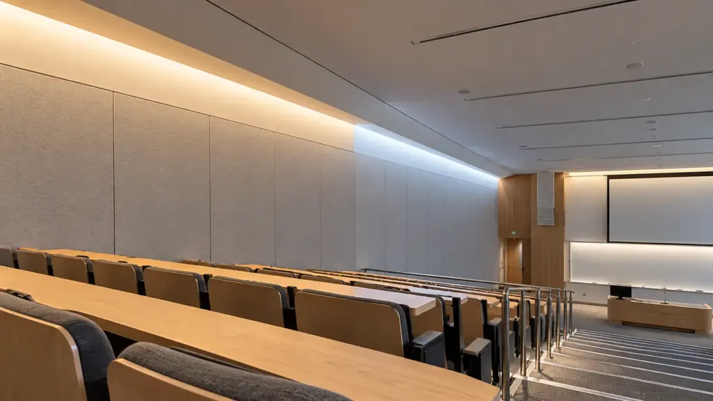 Lecture hall ceiling cove lit at 4000K in one zone and 6500K in the next