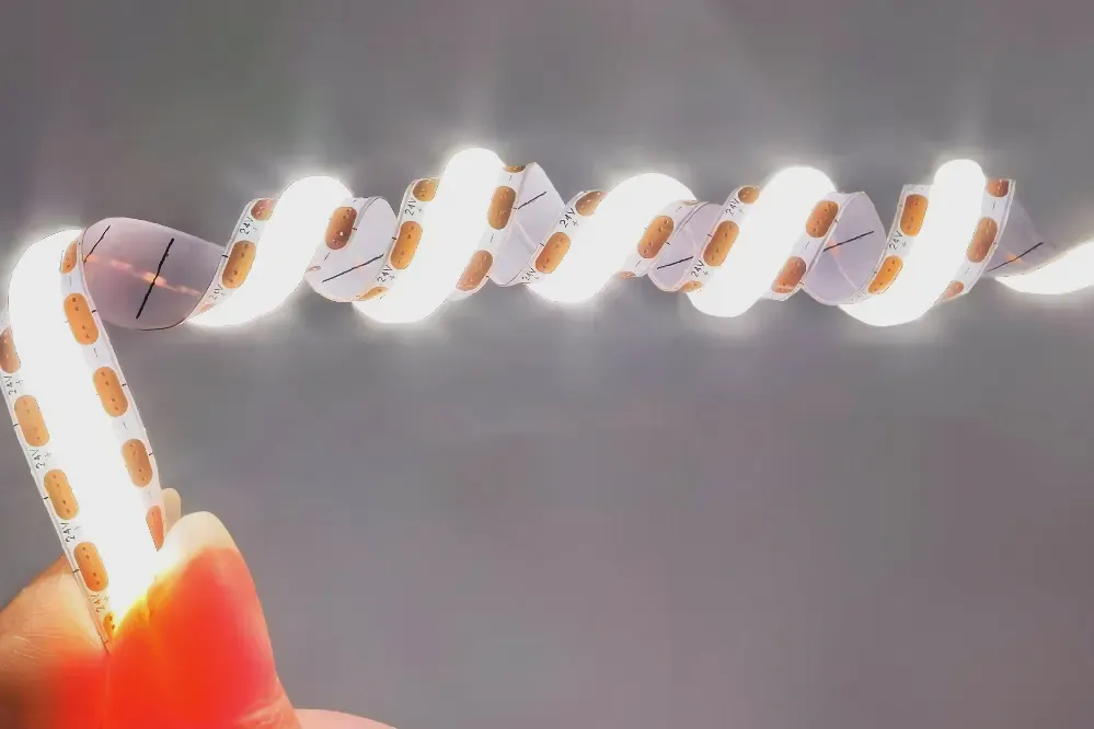 Lit SCOB LED strip twisted in a spiral between two fingers without dark sections